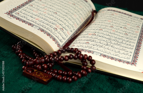 The open Quran book and rosary for religion background