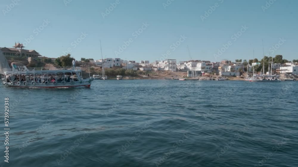 Nile river in Aswan, Egypt afternoon shot showing feluccas and boats in the river with elephantine Island (UNESCO World Heritage site) Nile river in Aswan, Egypt afternoon shot showing feluccas and boats in the river with elephantine Island (UNESCO World Heritage site)