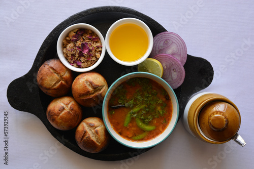 Roasted dal baati churma-a traditional north Indian cuisine in a cast iron plate