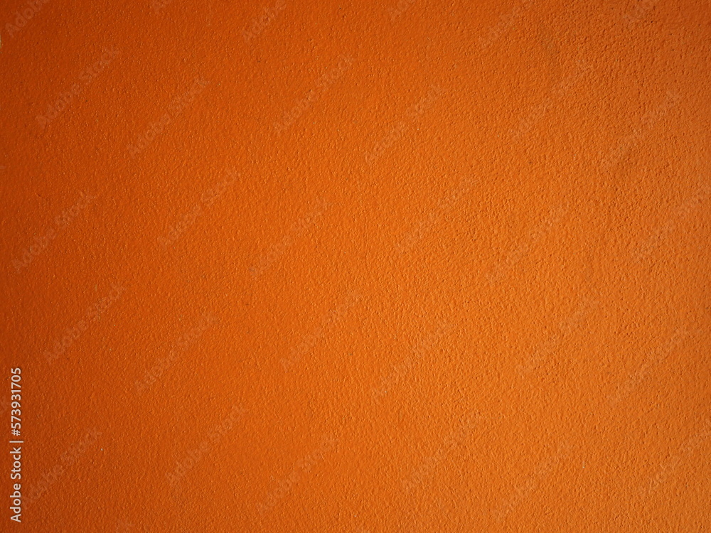 Fototapeta premium Empty orange concrete wall background, Vintage style for wallpaper, background and backdrop. Halloween background empty. Orange autumn hues background vivid light top
