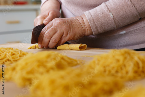 Closeup of the process of making cooking homemade pasta. Chef make fresh italian traditional pasta