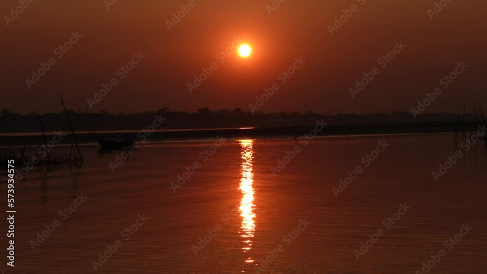 Golden sunset view over village riverside. The scenery of the Beautiful Sunset at the Riverside. Golden sunset view over village riverside. The scenery of the Beautiful Sunset at the Riverside.