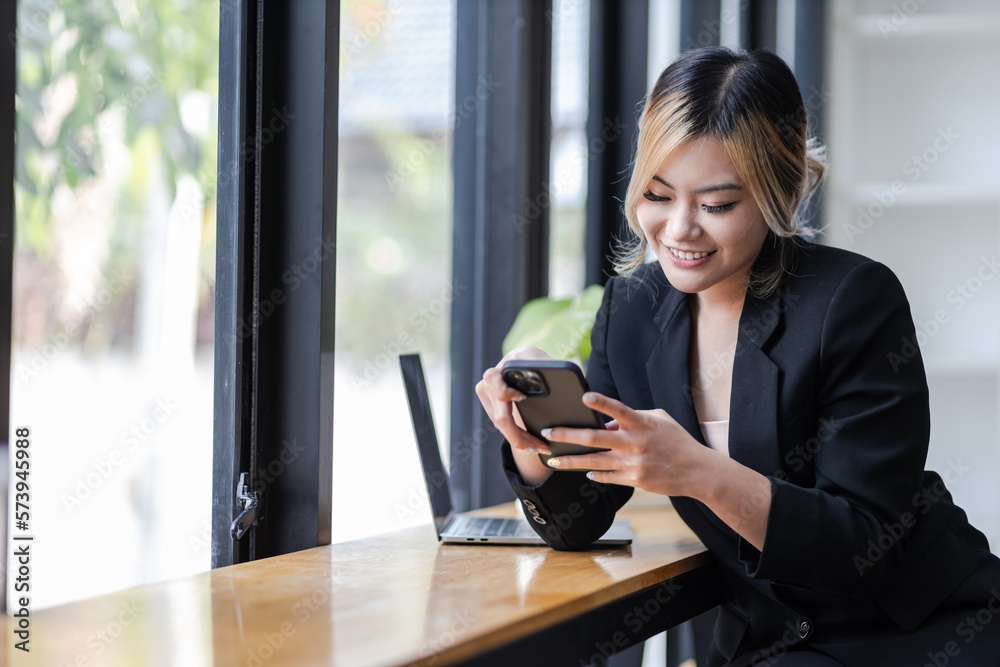 Portrait of a happy Asian businesswoman using mobile phone indoor, Asian businesswoman working in modern office. Portrait of a happy Asian businesswoman using mobile phone indoor, Asian businesswoman working in modern office.