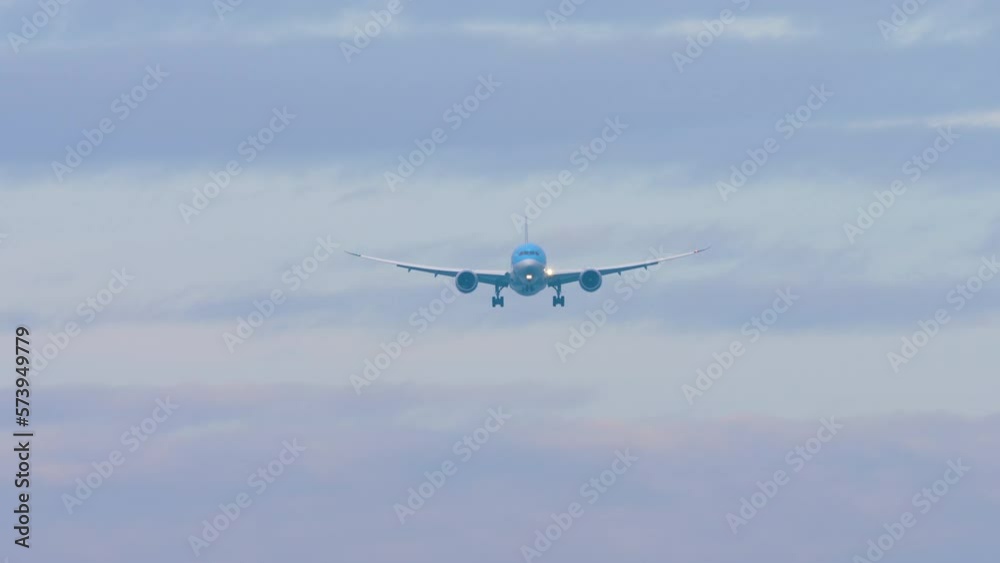 Jet unrecognizable aircraft in Blue livery approach landing, front view long shot. Footage of an airplane flies Jet unrecognizable aircraft in Blue livery approach landing, front view long shot. Footage of an airplane flies