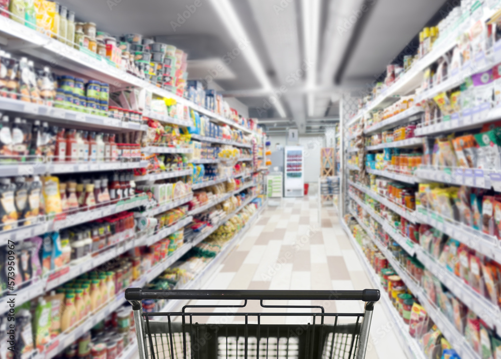 Abstract blurred supermarket.  choosing a dairy products at supermarket.empty grocery cart in an empty supermarket