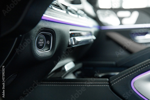 engine start stop button in a prestigious car with ambient lighting © AvokadoStudio