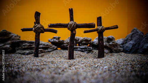 crosses stuck in the sand on an orange background