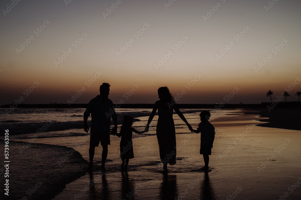Happy family with little kids enjoying time at sea in exotic country.