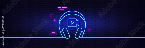 Neon light glow effect. Headphones with video camera line icon. Online conference sign. Virtual education symbol. 3d line neon glow icon. Brick wall banner. Headphones outline. Vector