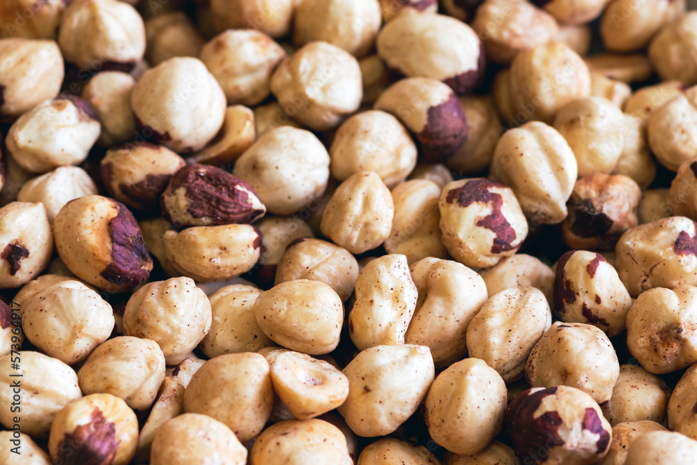 Peeled hazelnuts. Poorly peeled hazelnuts. Background of peeled hazelnuts.