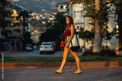 An attractive femal walking on the street of mediterranian turkish resort on a sunset. Alanya © Northern life