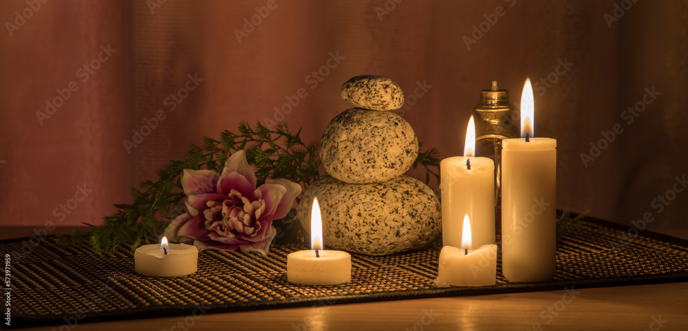 Candles lit at night and stones with decorative objects. Spa decoration. Candles lit at night and stones with decorative objects. Spa decoration.