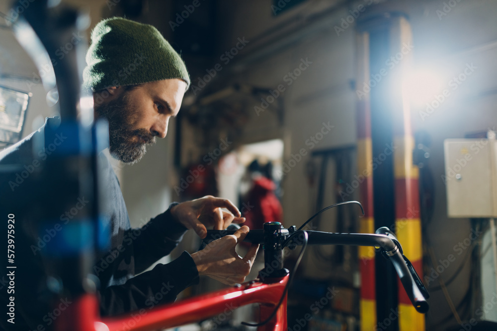 Mechanic repairman assembling custom bicycle in workshop Mechanic repairman assembling custom bicycle in workshop