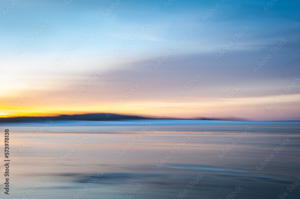 Blurred effect of seascape in the evening. Nature landscape background of Baltic Sea in Latvia. Intentional camera movement creating a dreamy background.