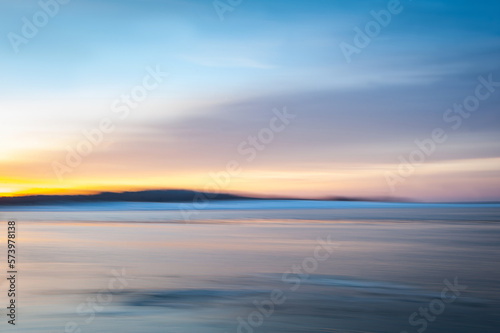 Blurred effect of seascape in the evening. Nature landscape background of Baltic Sea in Latvia. Intentional camera movement creating a dreamy background.