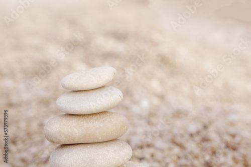 Harmony and Positive Mind. Relaxed spiritually hand arrangement pebble tower sea coastline landscape. Enjoying Life Concept. Mental Health Practice. Hand Setting Natural Pebble Stone to Balance