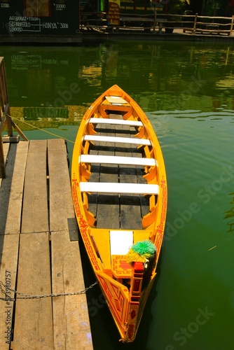 a yellow boat moored on the edge of an artificial lake at the festival marketplace