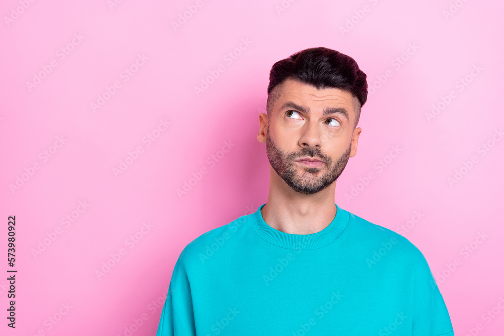 Photo of funny grimace guy handsome face look empty space suspicious information minded dont like opponent brand isolated on pink color background