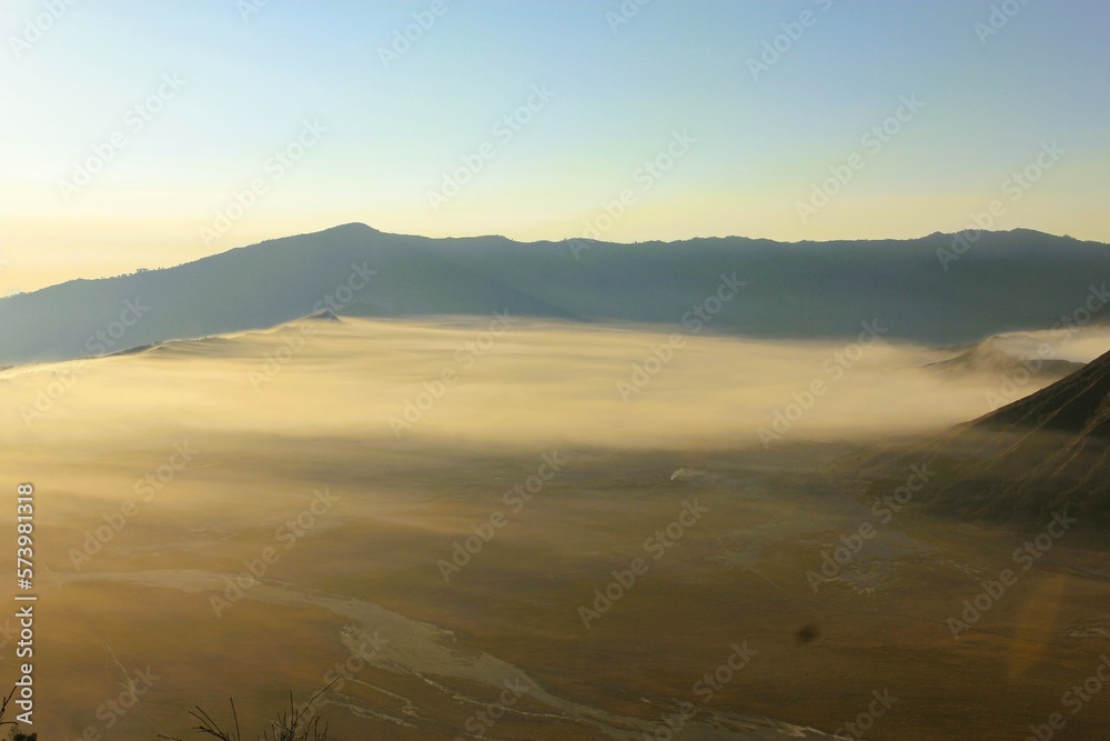 fog covers the surface of the crater area of ​​​​Mount Bromo at sunrise