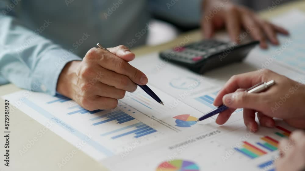 Executive team discussing the charts and graphs working in business strategy and financial plan to investment profit. Executive team discussing the charts and graphs working in business strategy and financial plan to investment profit.