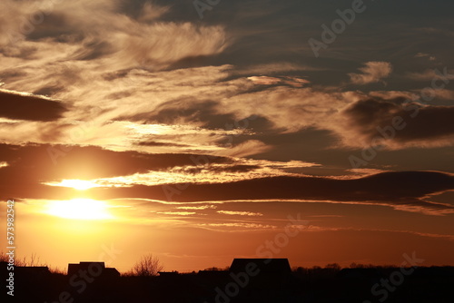A beautiful sunset with flowing orange and blue clouds.
