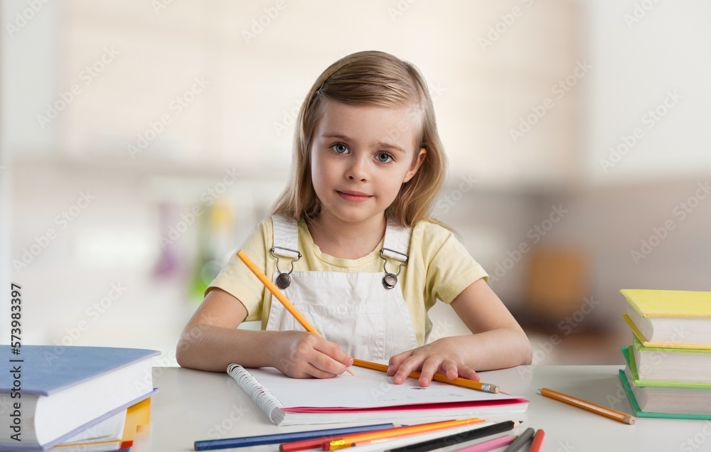 A cute little child draws at home A cute little child draws at home