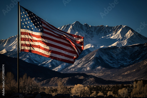 American Flag Landscape | In the early morning light, the American flag flies high against the clear blue sky, with a majestic mountain range visible in the distance. Ai