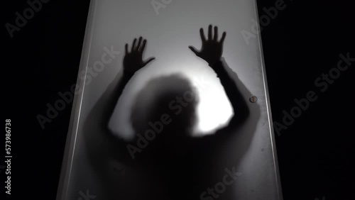 hands and body of raped woman silhouette- domestic family sexual violence at home in apartment - increase in rape and gender-based abuse - shock and fear due to a feminicide photo