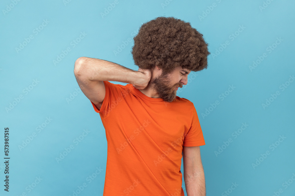 Man touching neck, feeling pain moving and turning head, suffering spine problems, osteochondrosis. Man touching neck, feeling pain moving and turning head, suffering spine problems, osteochondrosis.