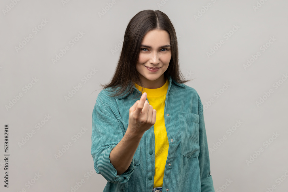 Attractive woman gesturing come to me, beckoning with finger, inviting for confidential talk. Attractive woman gesturing come to me, beckoning with finger, inviting for confidential talk.