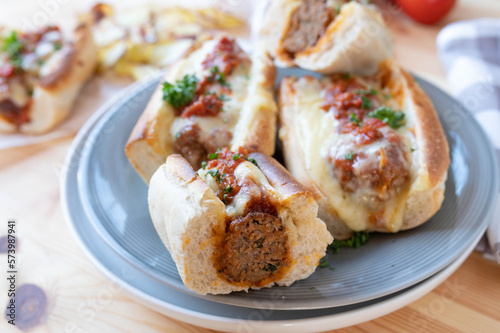 Italian meatball sandwiches with tomato sauce and cheese on a plate