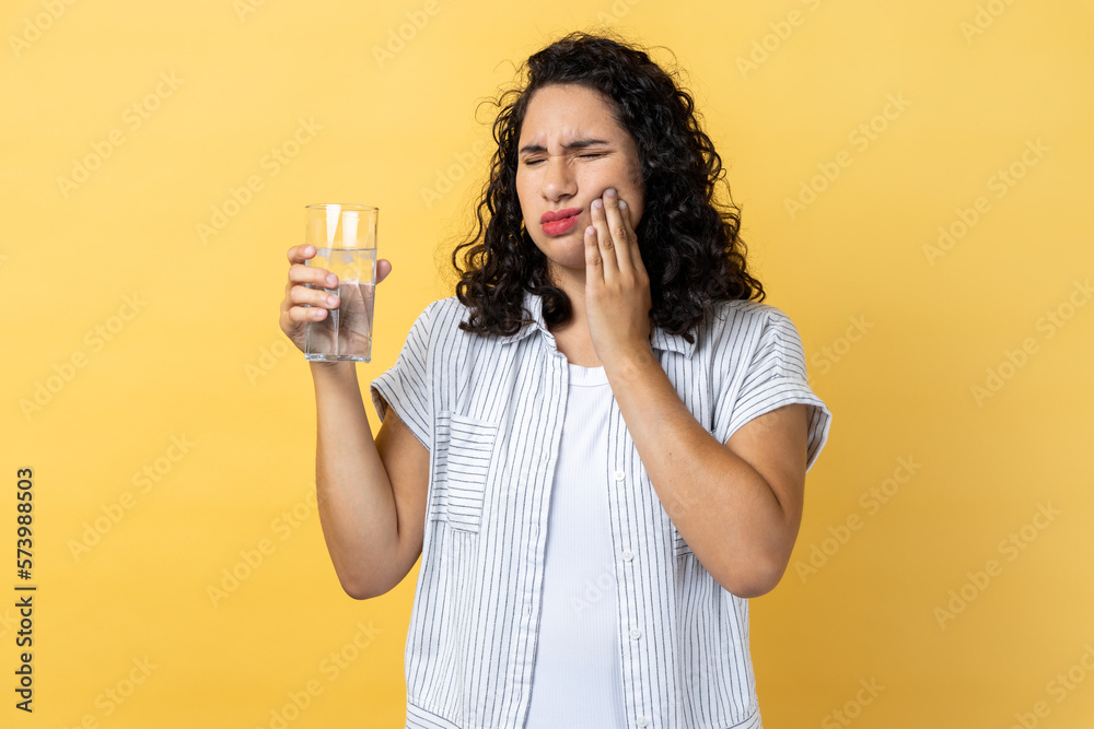 Woman standing and touching his cheek because feeling pain on tooth, after drinking hot tea. Woman standing and touching his cheek because feeling pain on tooth, after drinking hot tea.