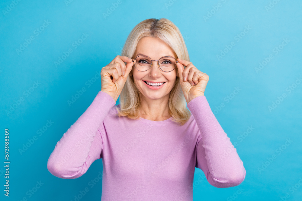 Photo of mature age beautiful adorable lady wear purple shirt hold glasses spectacles checkup fix vision isolated on aquamarine color background