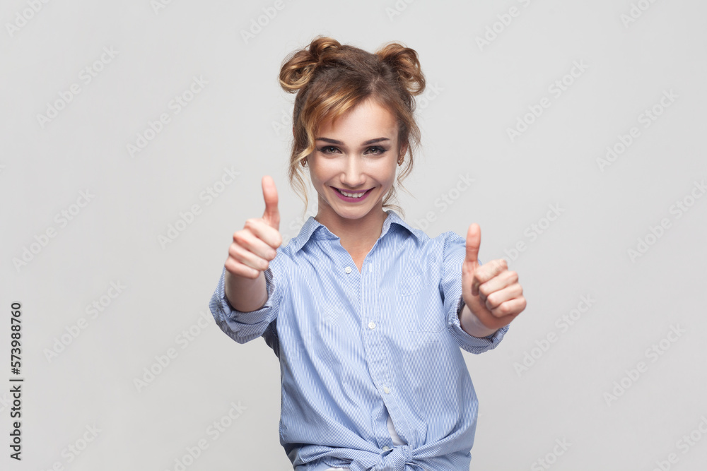 Woman showing like gesture, satisfied with something, keeps thumb raised, shows her agreement. Woman showing like gesture, satisfied with something, keeps thumb raised, shows her agreement.