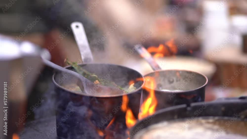 Boiling tee in a pot mug on fire, in the forest in the fresh air Boiling tee in a pot mug on fire, in the forest in the fresh air