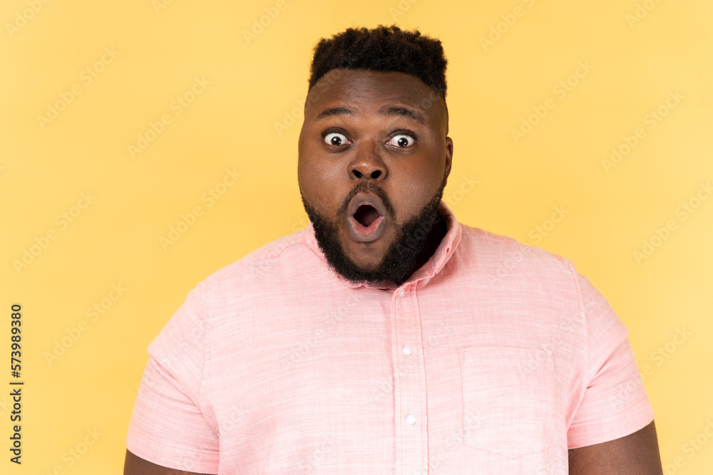 Man has shocked expression, looking at camera with open mouth and amazed big eyes. Man has shocked expression, looking at camera with open mouth and amazed big eyes.