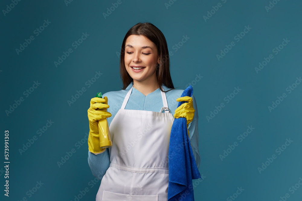 woman in cleaner apron wieaning rag and detergent sprayer woman in cleaner apron wieaning rag and detergent sprayer