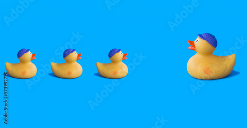 Yellow toy duckling for bathing on the blue background. Close-up. Copy space.