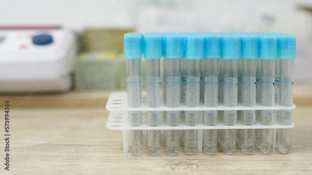 A close view of liquid pouring into test tube in white laboratory background