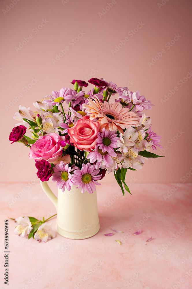 Beautiful fresh spring flowers. Pink bouquet of flowers in vase, on pink background. Beautiful fresh spring flowers. Pink bouquet of flowers in vase, on pink background.
