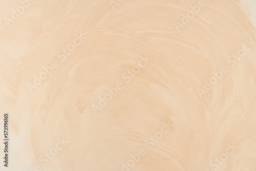Overlay for your design. Light beige background, smeared powder cosmetics vanilla shade. The beige texture paints a horizontal surface with space to copy. High quality photo