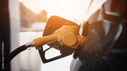 Gasoline being refilled at a petrol station. Refueling Diesel fuel is used to power a car.