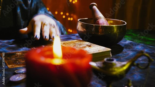 Fortune teller hands with rings by candlelight in the twilight fortune telling by tarot cards on a dark velvet table. Medium plan. horizontal panorama photo