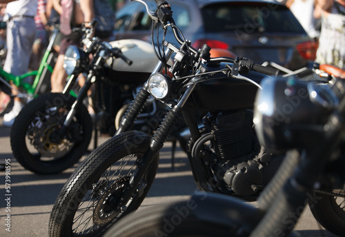 Custom bobber motorbike painted in matte black. Classic tuner motorcycle on bike show.