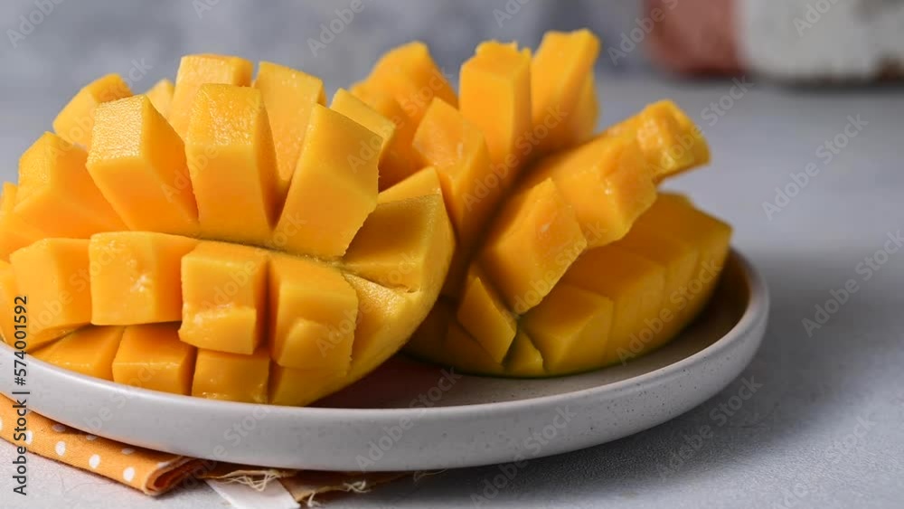 Fresh mango fruit halves in a plate. Exotic fruits. Fresh mango fruit halves in a plate. Exotic fruits.