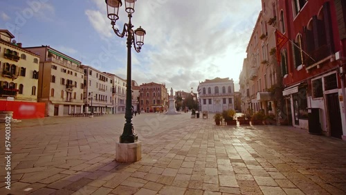 Deserted Venice square with street pole among buildings