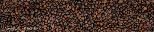 Fresh roasted brown coffee beans panoramic background