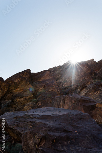 Sunlight streaming above desert rock in Tahquitz Canyon in Southern California in the Coachella Valley near Palm Springs.