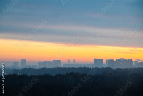 early winter cold dawn over park and city on horizon