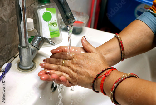 Cropped Image Of an asian Woman Washing Hands In Sink At Home. Selective focus